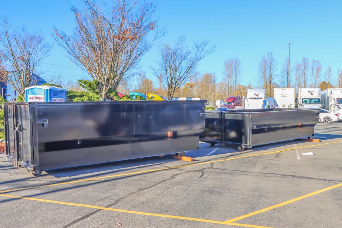 Professional dumpster rental service with roll-off container on residential driveway in Daytona Beach Shores